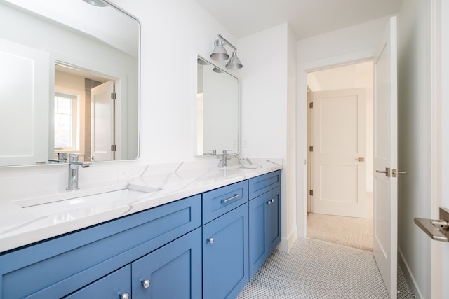 bathroom featuring double vanity, tile patterned flooring, and a sink
