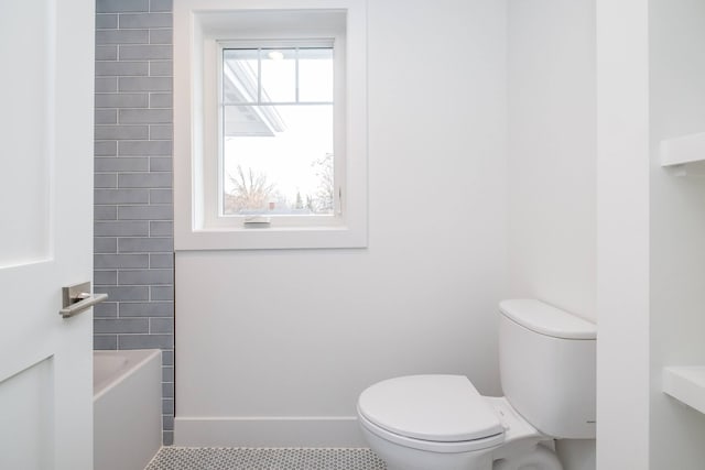 full bath with toilet, tile patterned floors, and a bathtub