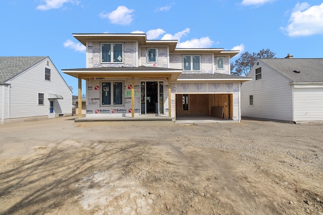 rear view of house with driveway and a porch