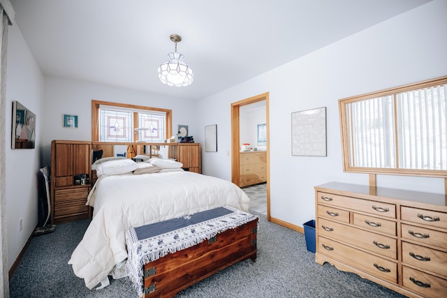 carpeted bedroom featuring connected bathroom