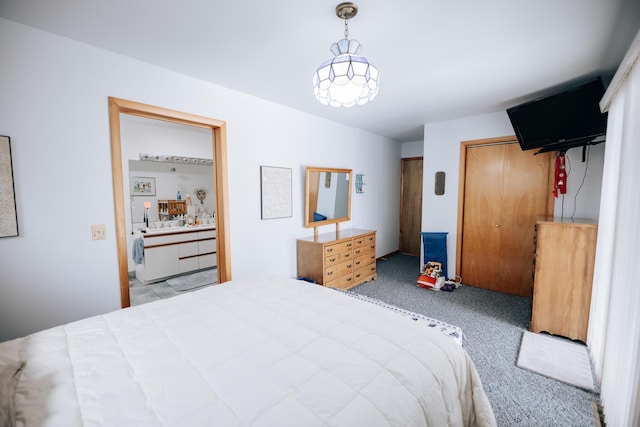 bedroom featuring light carpet and ensuite bath