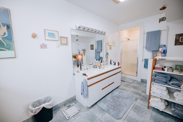 bathroom featuring vanity, tile patterned flooring, and a shower with door