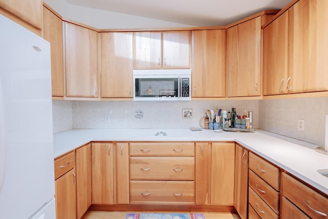 kitchen featuring white refrigerator, tasteful backsplash, and electric stovetop