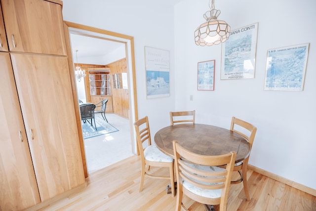 dining area featuring an inviting chandelier and light wood-type flooring