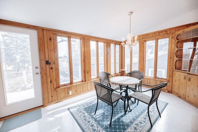 sunroom with an inviting chandelier and vaulted ceiling