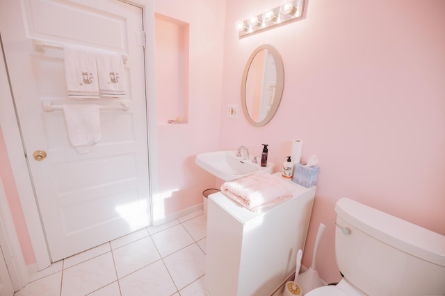 bathroom with sink, tile patterned floors, and toilet