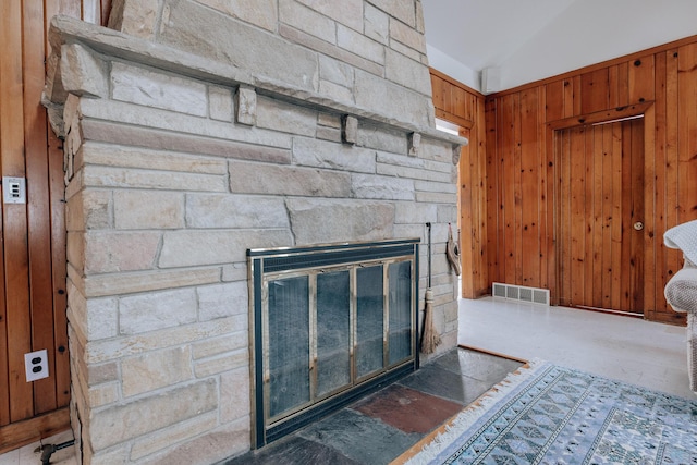 room details with a fireplace and wood walls