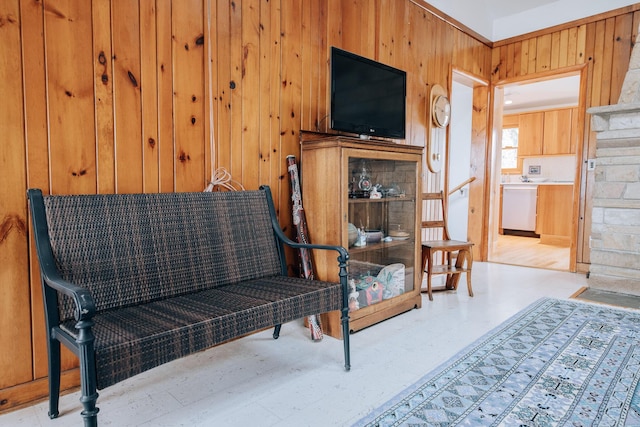 sitting room with wooden walls and light wood-type flooring