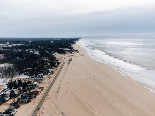 drone / aerial view with a beach view and a water view