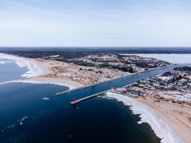 drone / aerial view featuring a water view and a beach view