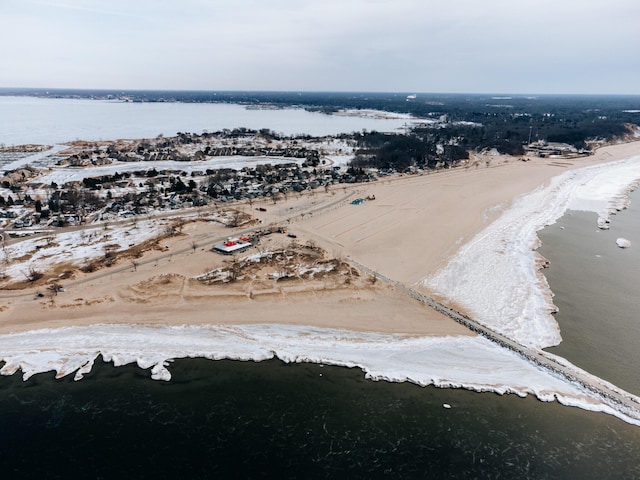 drone / aerial view featuring a water view and a beach view