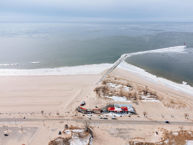 birds eye view of property featuring a water view and a beach view