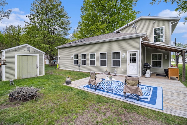 rear view of house with a shed, a wooden deck, and a lawn