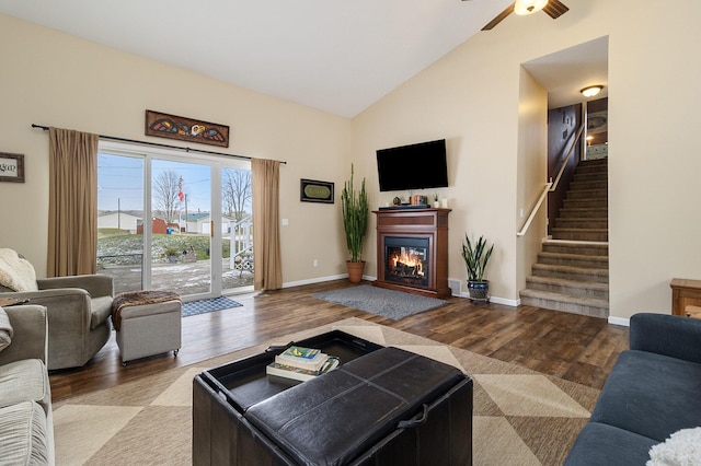 living room featuring ceiling fan, hardwood / wood-style floors, and high vaulted ceiling