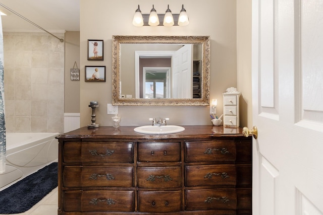 bathroom featuring tiled shower / bath, tile patterned floors, and vanity