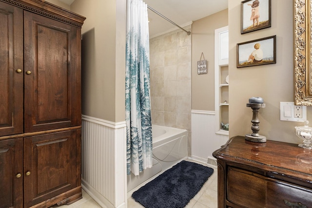 bathroom with shower / bathtub combination with curtain and tile patterned floors