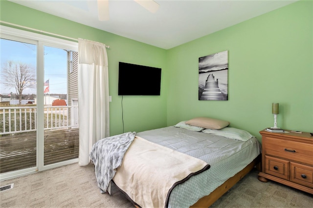 bedroom with ceiling fan, light carpet, and access to outside