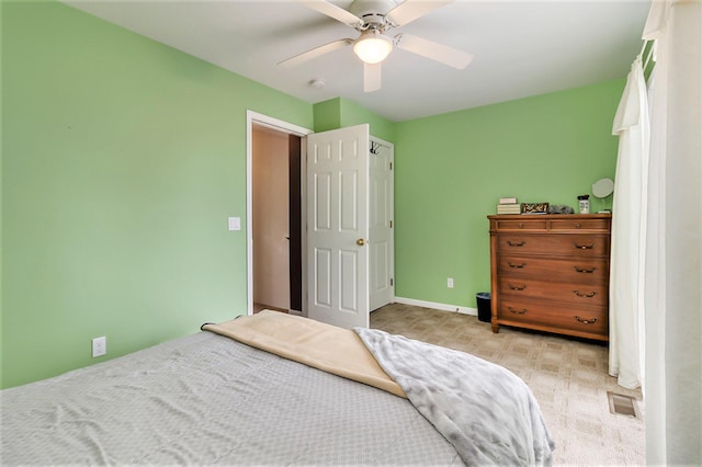 bedroom featuring light colored carpet and ceiling fan