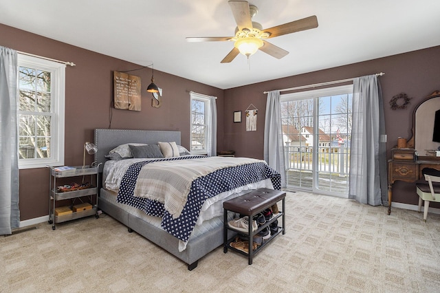 carpeted bedroom featuring access to exterior and ceiling fan