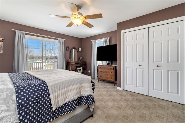 carpeted bedroom with access to exterior, a closet, and ceiling fan