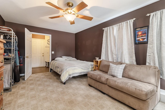 bedroom with light colored carpet and ceiling fan