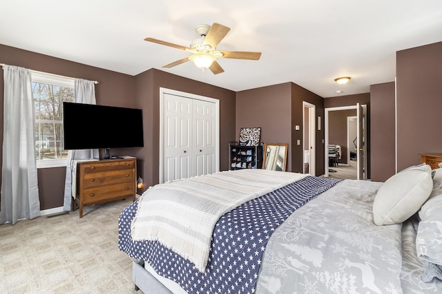 carpeted bedroom with a closet and ceiling fan