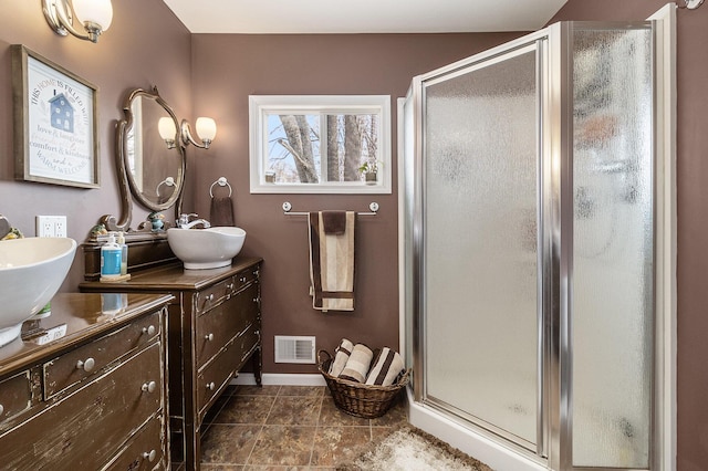 bathroom with vanity, a shower with shower door, and tile patterned flooring