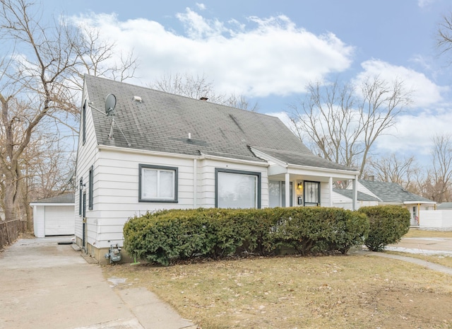 view of front of house featuring a garage, an outdoor structure, and a front yard