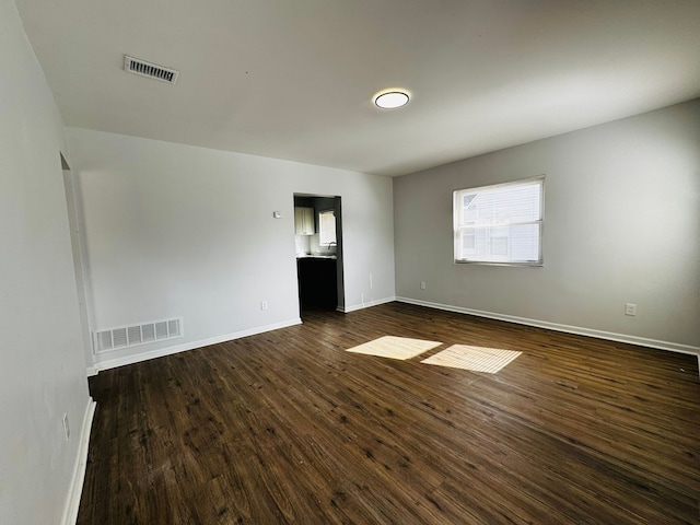 unfurnished room featuring dark hardwood / wood-style floors