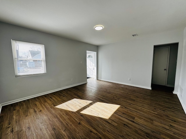 unfurnished room with dark hardwood / wood-style floors