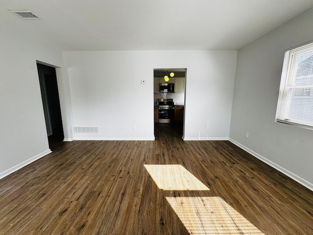 unfurnished room featuring dark hardwood / wood-style flooring