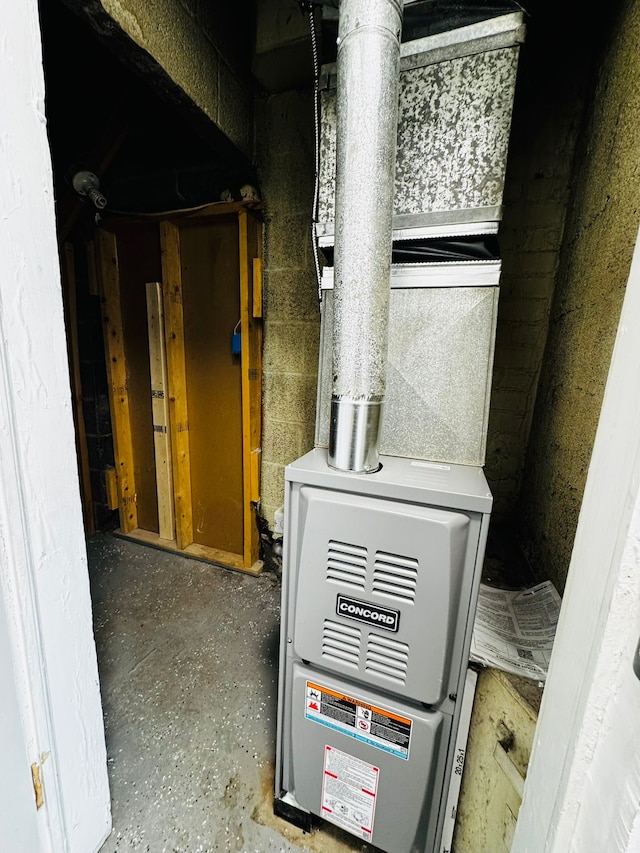 utility room featuring heating unit