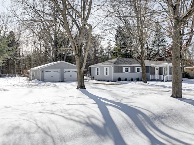 view of front of house with a garage and an outdoor structure