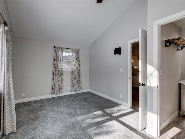 carpeted spare room with lofted ceiling