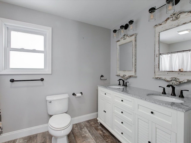 bathroom featuring vanity, hardwood / wood-style floors, and toilet