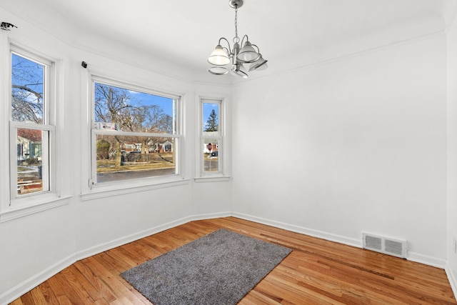 dining space featuring hardwood / wood-style flooring and a chandelier