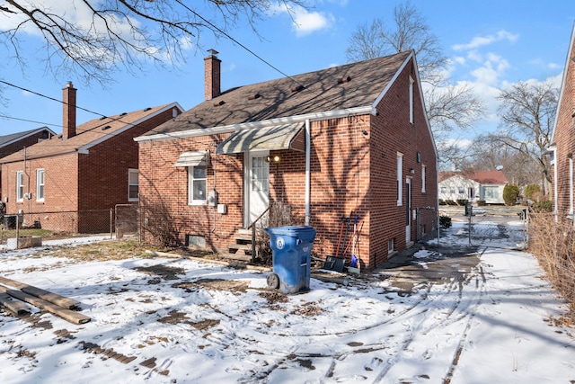 view of snow covered back of property