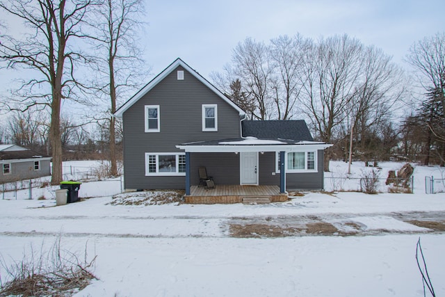 view of snow covered back of property