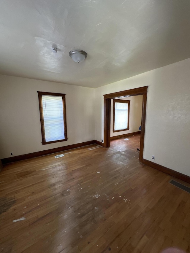 unfurnished room featuring dark hardwood / wood-style flooring