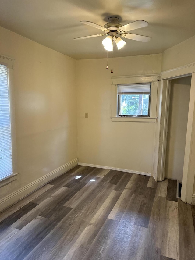 unfurnished bedroom featuring dark wood-type flooring, a closet, and ceiling fan