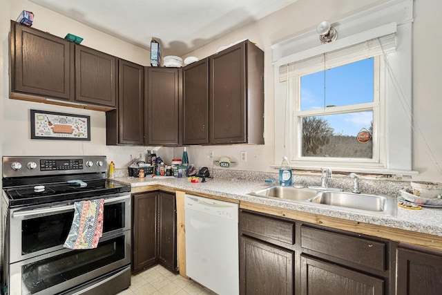 kitchen with double oven range, a sink, dark brown cabinetry, light countertops, and dishwasher