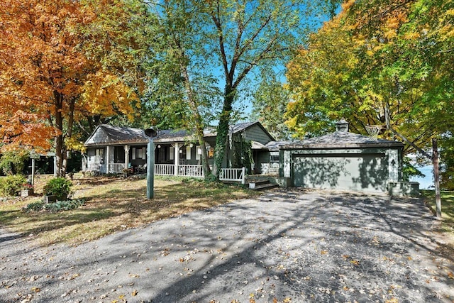 ranch-style house featuring a garage and a porch