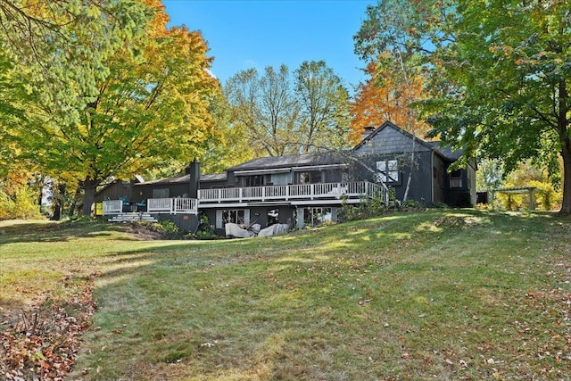 back of house with a wooden deck and a yard