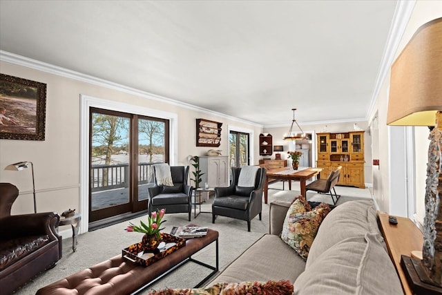 living room featuring crown molding, an inviting chandelier, and light carpet