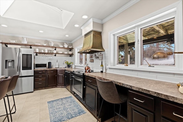 kitchen featuring crown molding, stainless steel fridge, electric range, custom range hood, and decorative backsplash