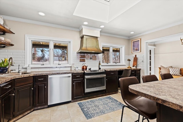 kitchen featuring sink, dark brown cabinets, stainless steel appliances, light tile patterned flooring, and custom exhaust hood