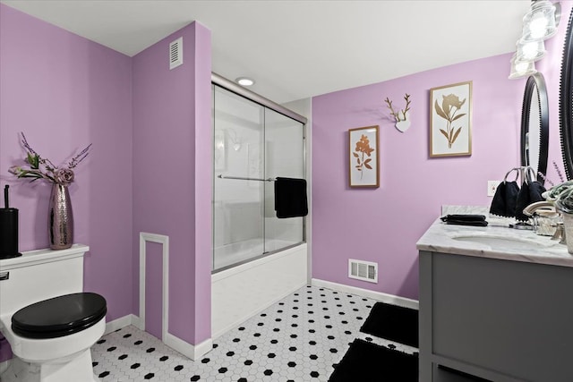 full bathroom with vanity, tile patterned floors, shower / bath combination with glass door, and toilet