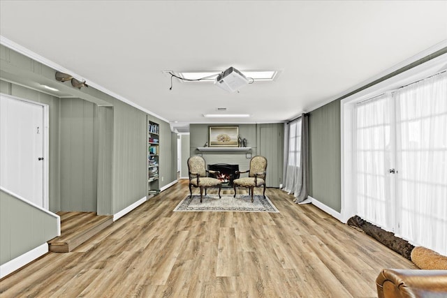 dining space featuring crown molding and light hardwood / wood-style floors