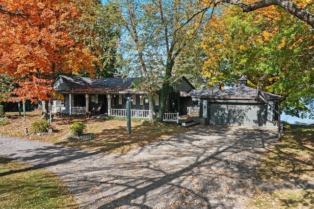 ranch-style house featuring a porch and a garage