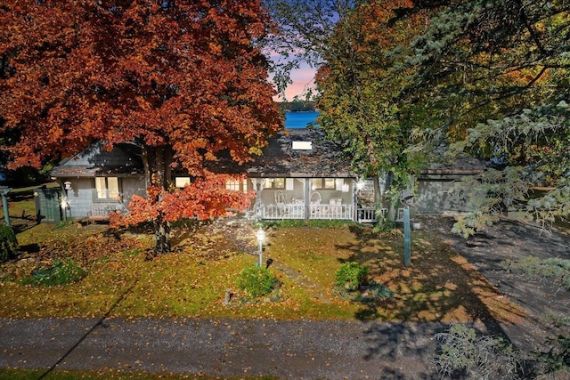 obstructed view of property with a porch